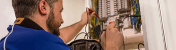 a man working on a electrical panel